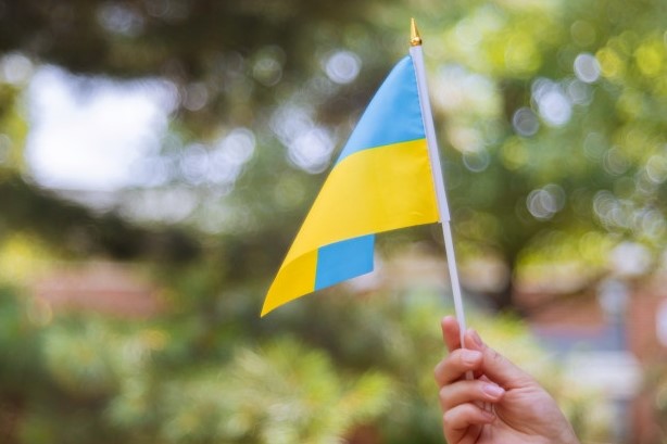 Female Hand with Ukraine National Flag - Happy Ukraine Independence Day 2022